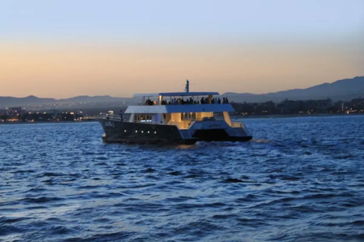 100' Party Catamaran cruising at dusk