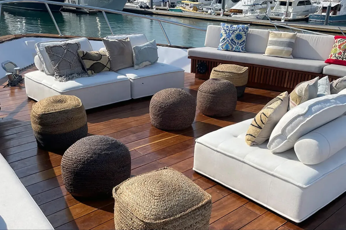 Lounge with white sofas and woven poufs