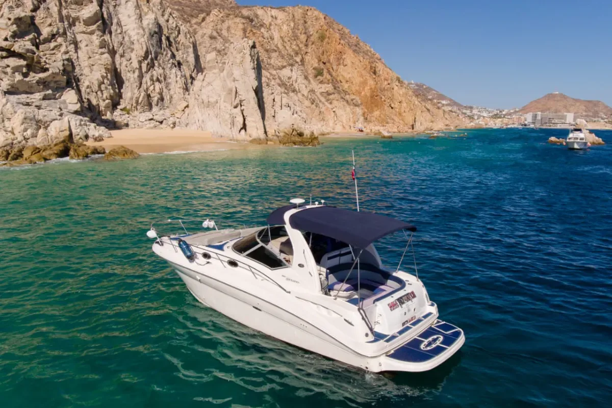 32' Sea Ray passing beneath Cabo's rocky cliffs