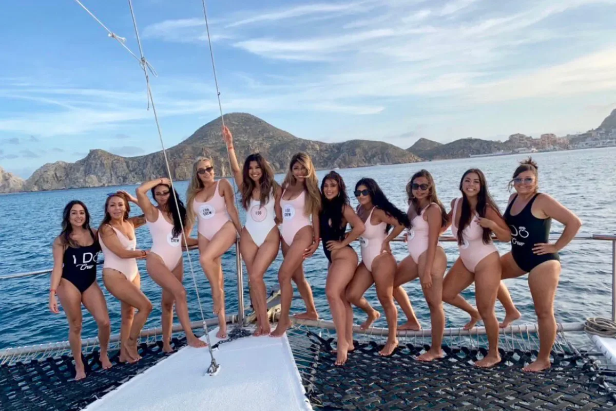 Friends posing along the trimaran's bow
