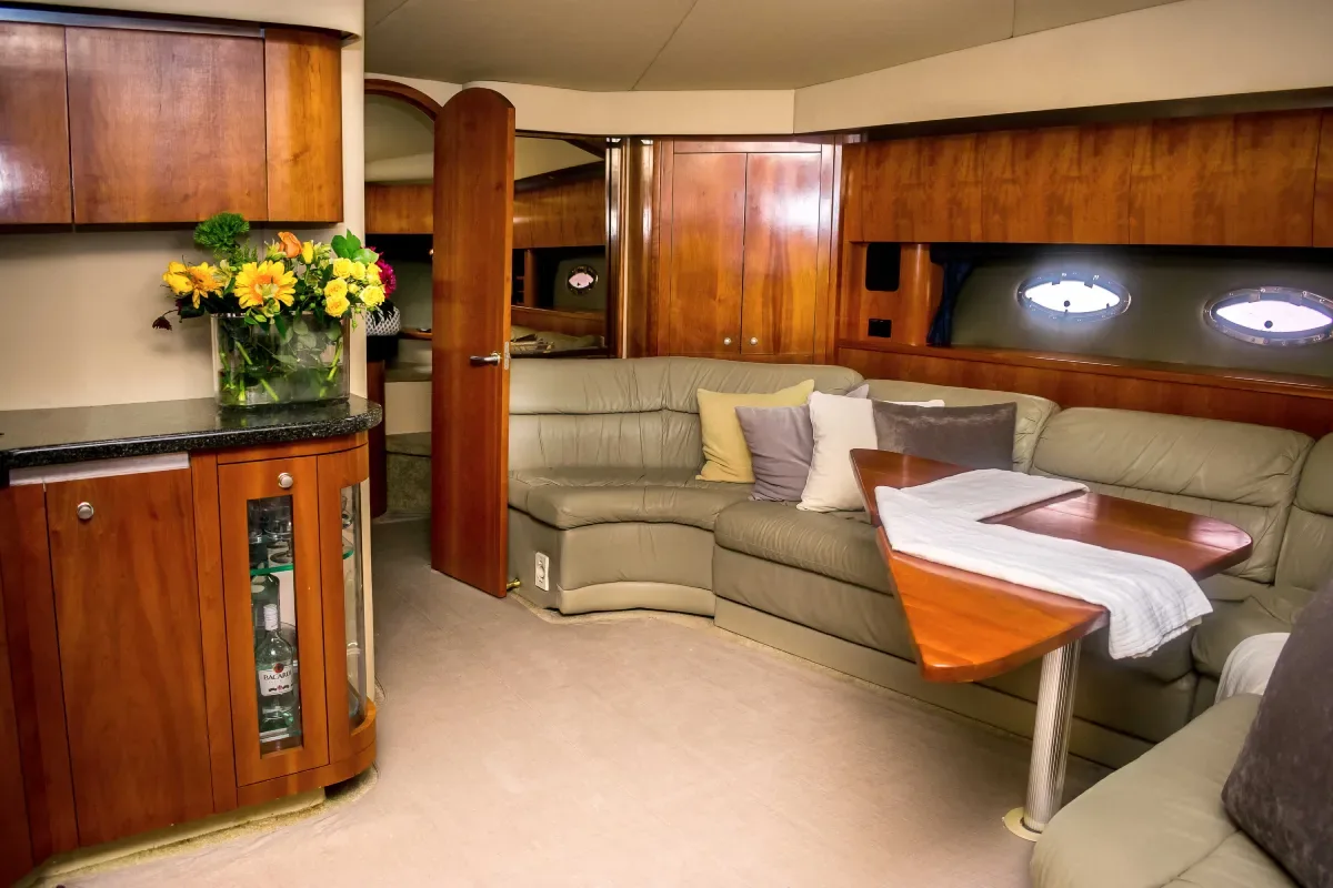Salon and galley with warm wood finishes
