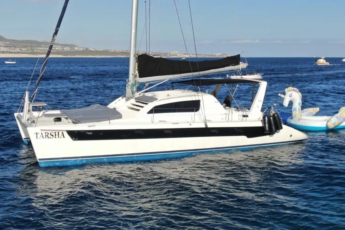 Leopard catamaran at anchor with an inflatable float