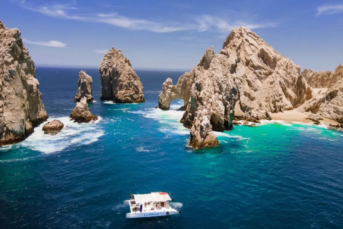 Aerial view of the catamaran beside the Land's End rocks