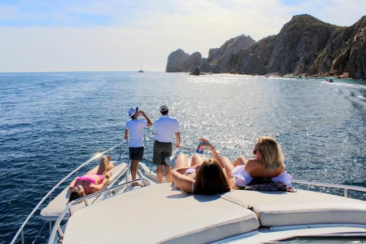 Guests on the bow near the Land's End cliffs